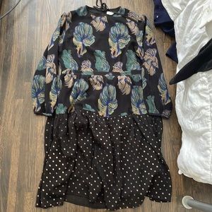 Black dress with green leaves and gold dots on the bottom